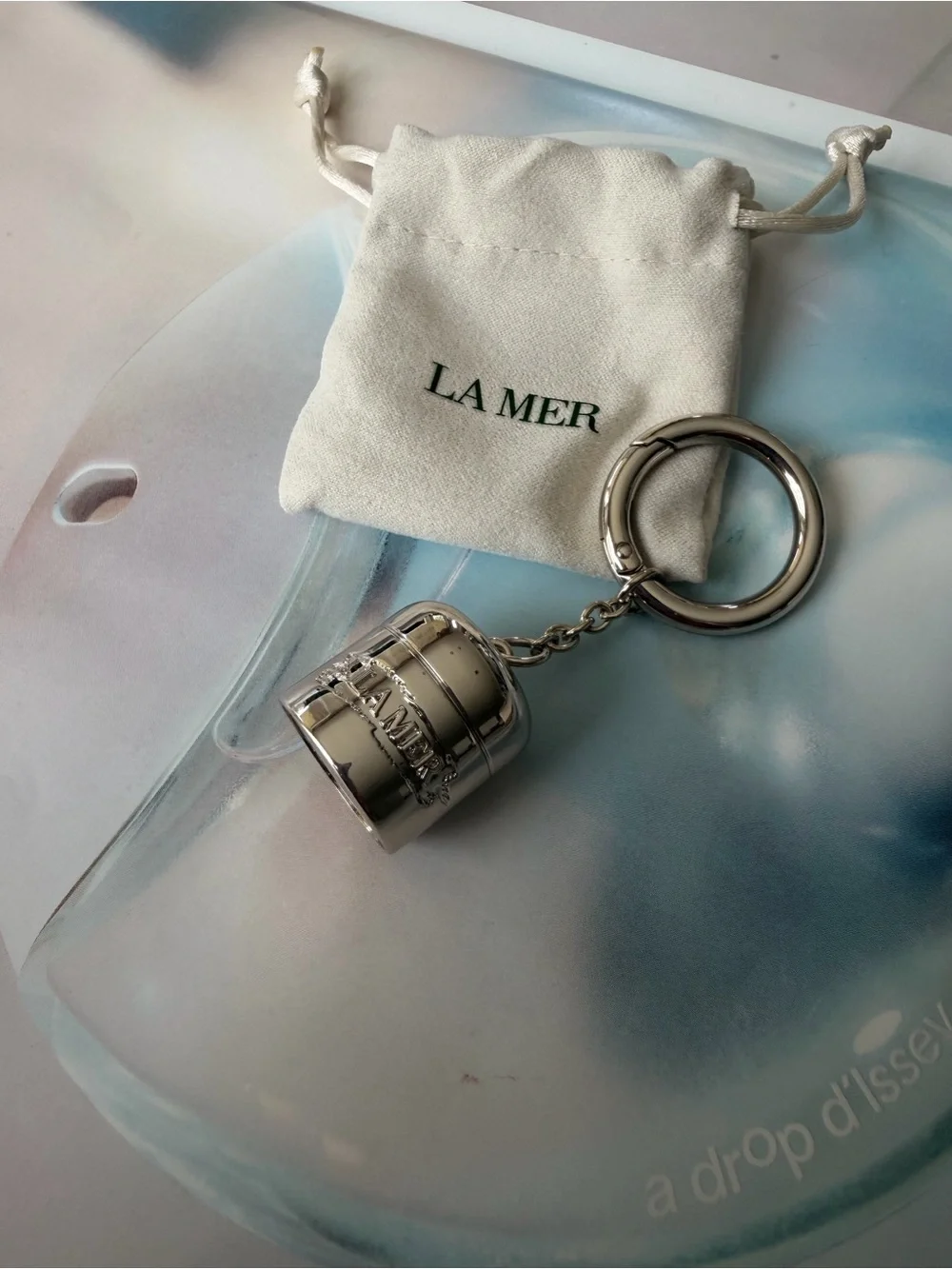 La Mer Silver Tone bag charm / Keychain with Drawstring Pouch
